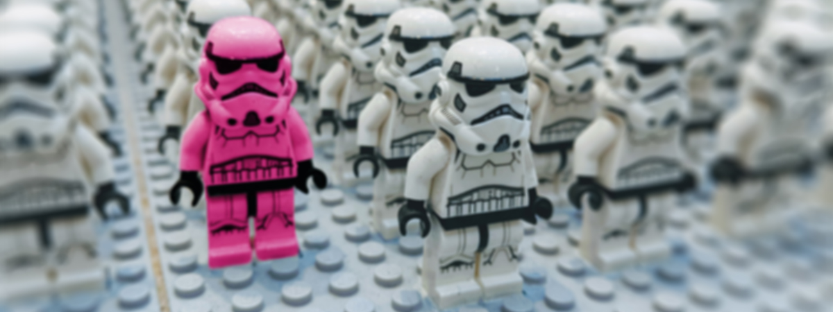 A pink Lego stormtrooper leading a group of Lego soldiers. Contact us for brand identity services