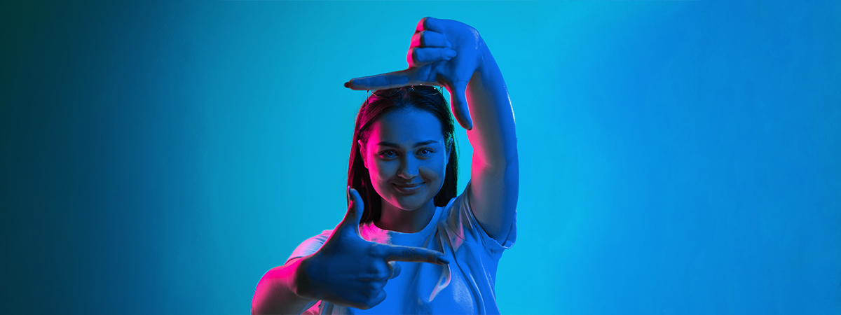 Woman with hands raised against blue background. Transform marketing with Lean mindset for optimal results.