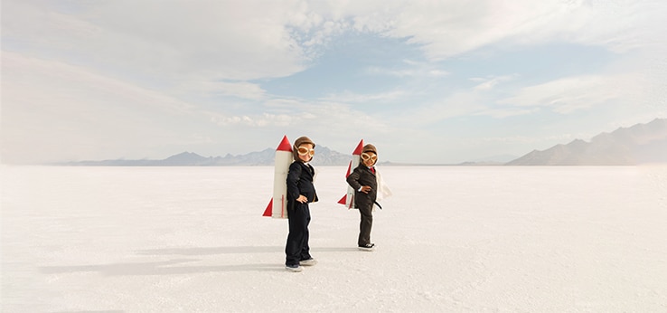 Two people in a desert with a rocket, showcasing the importance of choosing the right communication strategy for marketers.